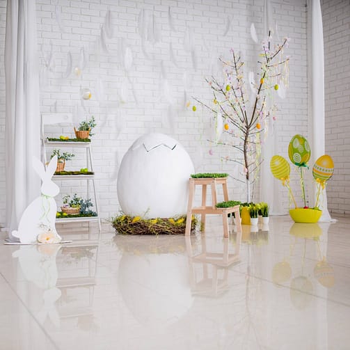 Bright studio prepared for Easter and decorated with eggs and greenery